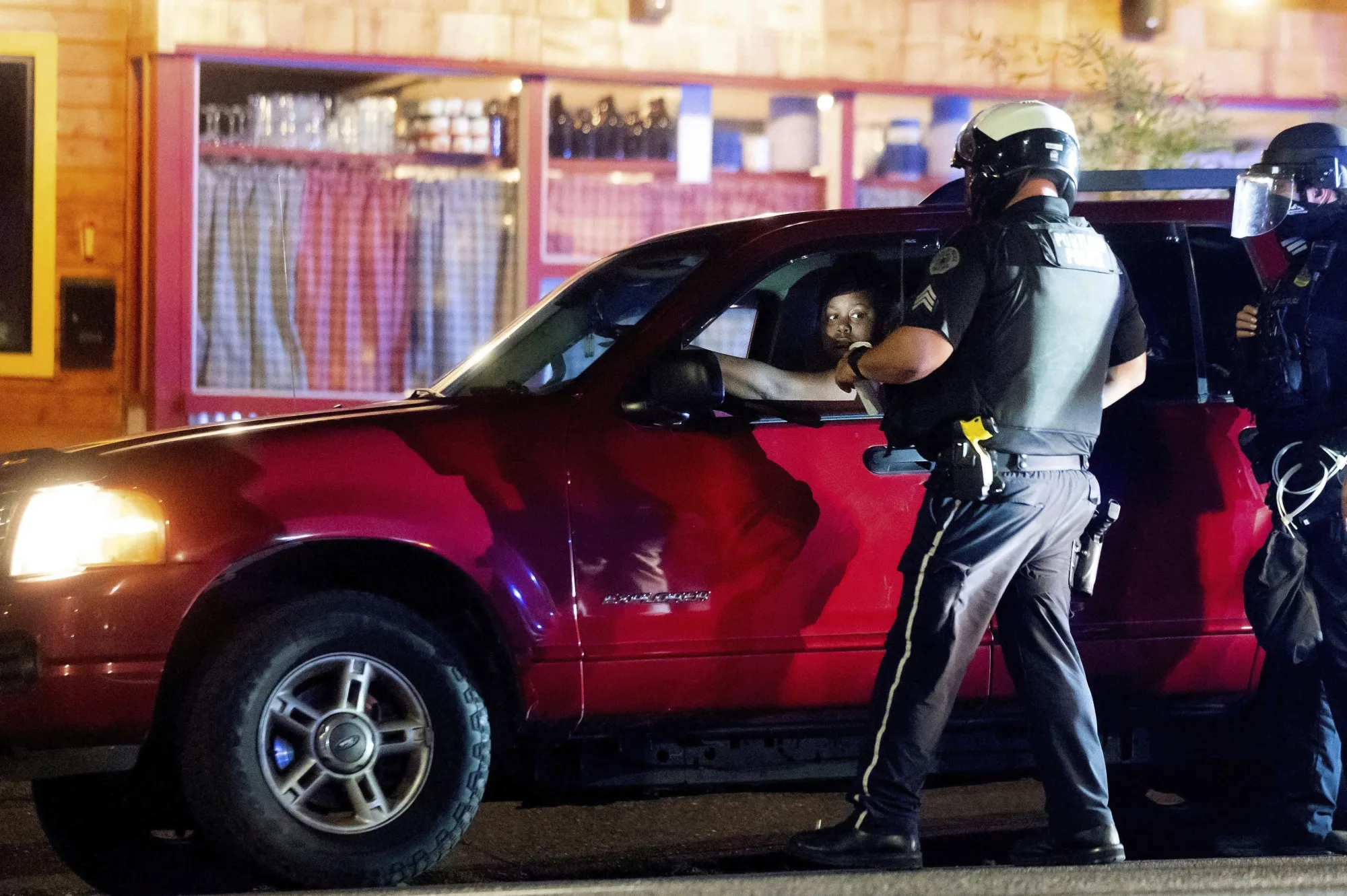 Police officers make a traffic stop near a Black Lives Matter protest on Sept. 4.
