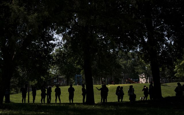 People wait in line during a pop-up grocery event at Powderhorn Park in Minneapolis, Minnesota on July 24, 2020.