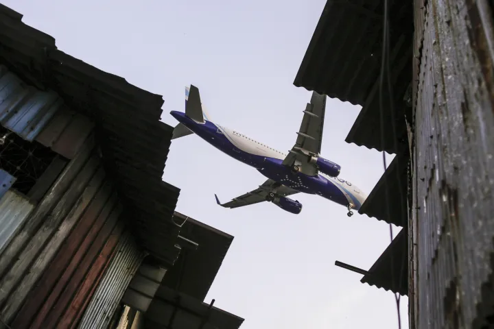 An Airbus A320 airliner operated by IndiGo flies over Mumbai.