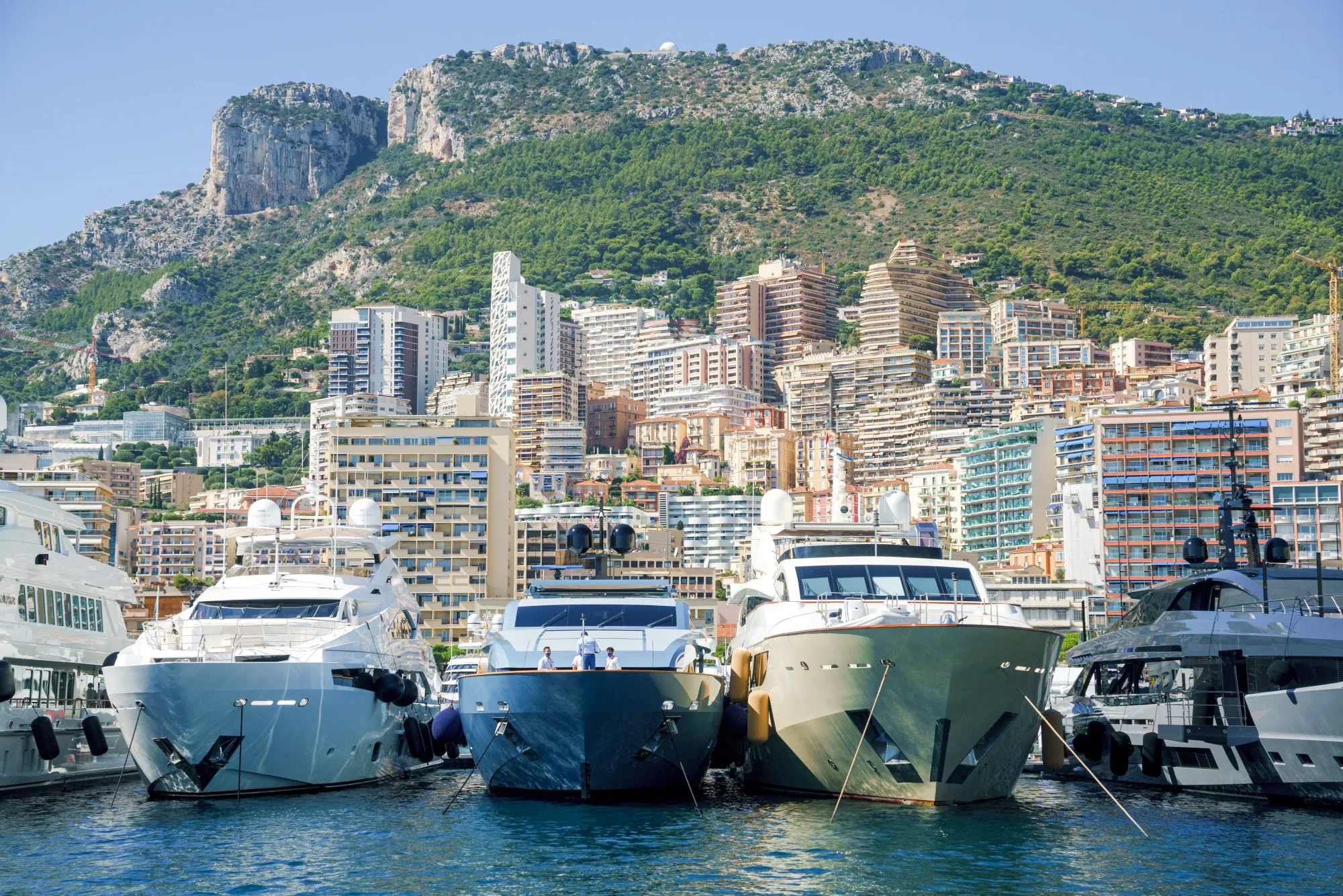 Luxury yachts in the harbor against a Monaco skyline during the opening day of the Monaco Yacht Show.