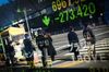 Pedestrians are reflected in an electronic stock board outside a securities firm in Tokyo, Japan, on Tuesday, Feb. 6, 2018. Japan's broad Topix index and blue-chip Nikkei 225 Stock Average were poised to enter a correction as the nation's shares headed for the biggest decline since June 2016, following U.S. peers lower amid rising concern that inflation will force interest rates higher.