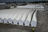 A worker walks past wind turbine blades awaiting transport in Fort Madison, Iowa.