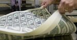 A pressman aerates a stack of 2017 50 subject uncut sheet of $1 dollar notes at the U.S. Bureau of Engraving and Printing in Washington, D.C.