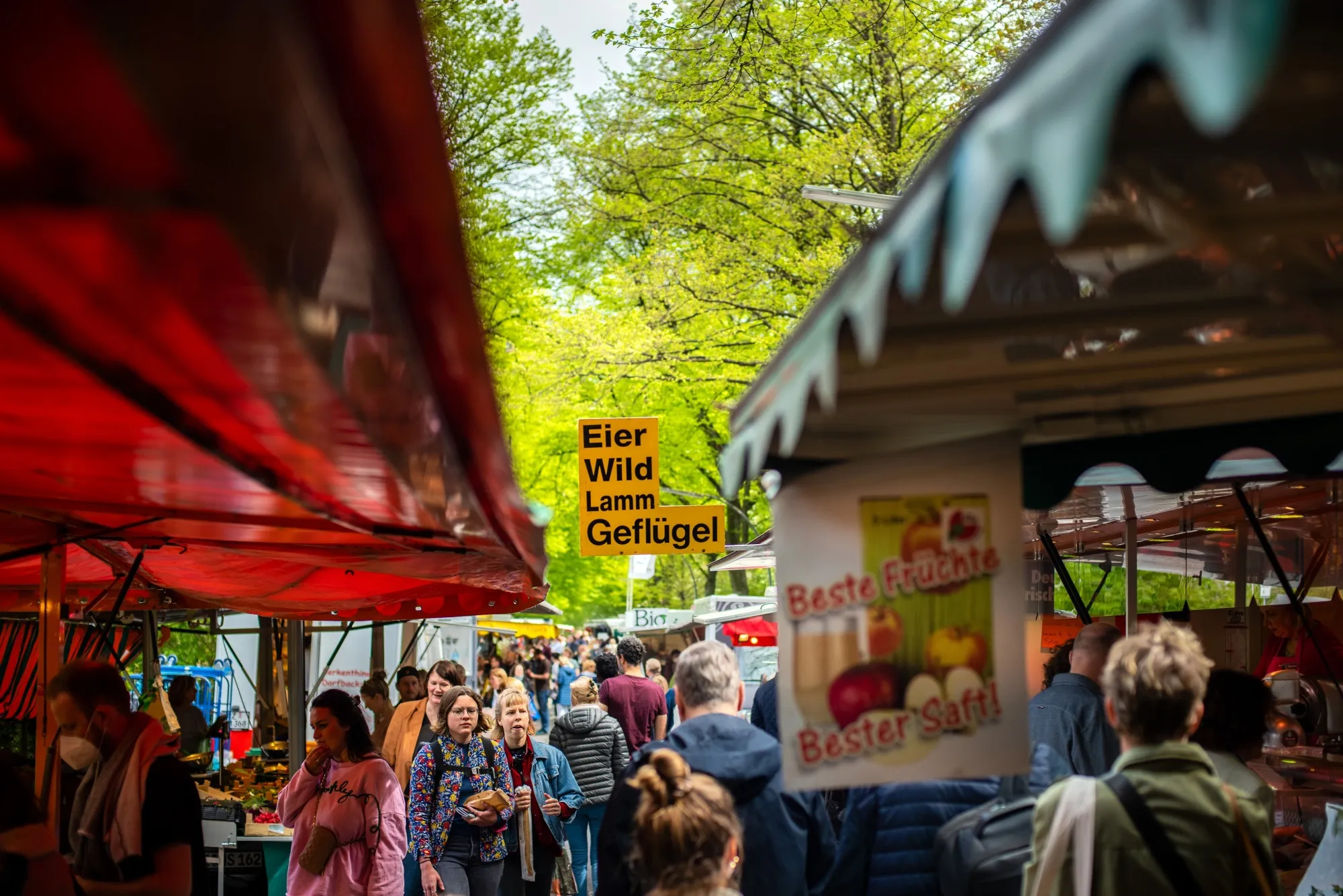 Customers browse stalls at a farmers' market in Hamburg.