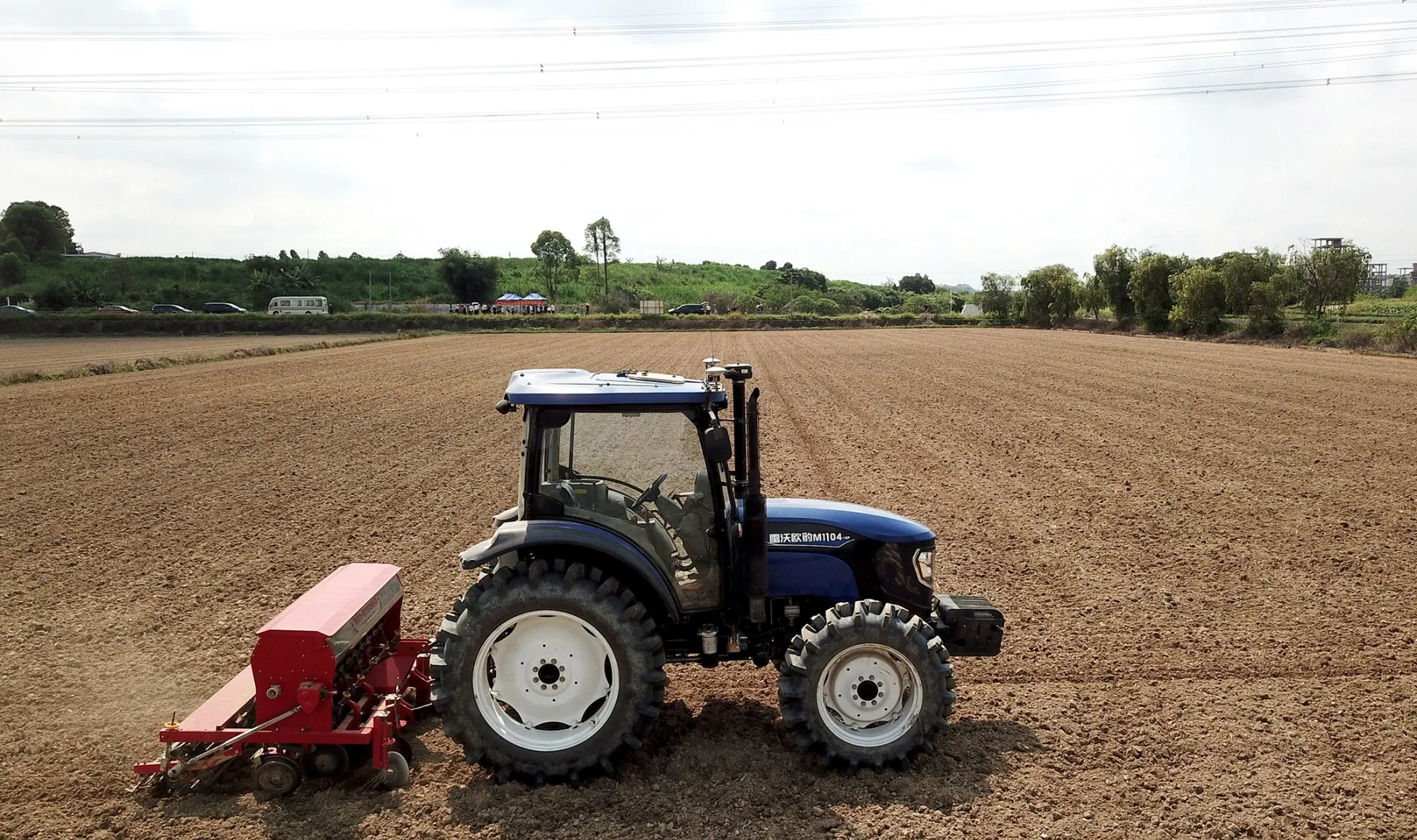 A photo taken on May 9, 2020, shows an unmanned tractor plowing in the field at an education and research base of South China Agricultural University in Guangzhou, Guangdong province.