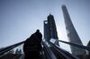 Pedestrians ride on an escalator in Pudong's Lujiazui Financial District in Shanghai, China, on Thursday, Feb. 18, 2021. China's stock benchmark erased gains after briefly surpassing its 2007 closing peak, as mainland financial markets opened for the first time following the Lunar New Year break.