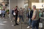 Customers line up outside an Applestore in Perth, Australia, on May 9.