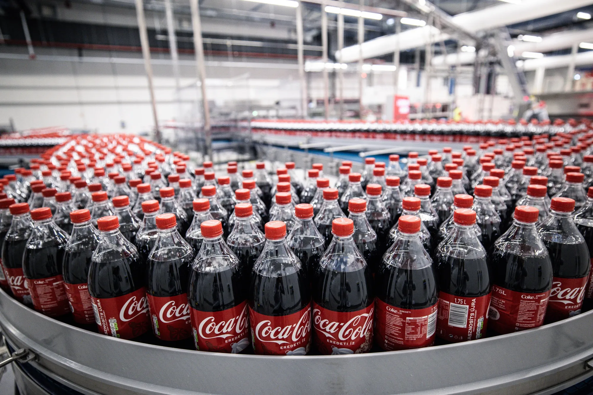 Bottles of Coca-Cola move along a conveyor belt on the production line in Dunaharaszti, Hungary.