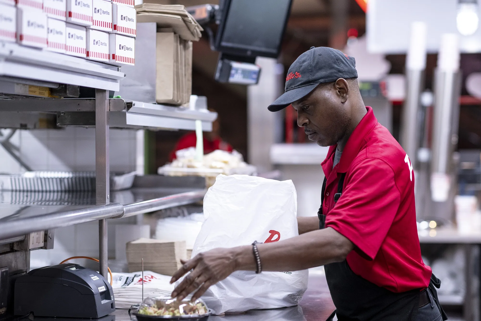An employee prepares a takeout order at a restaurant in Chicago.