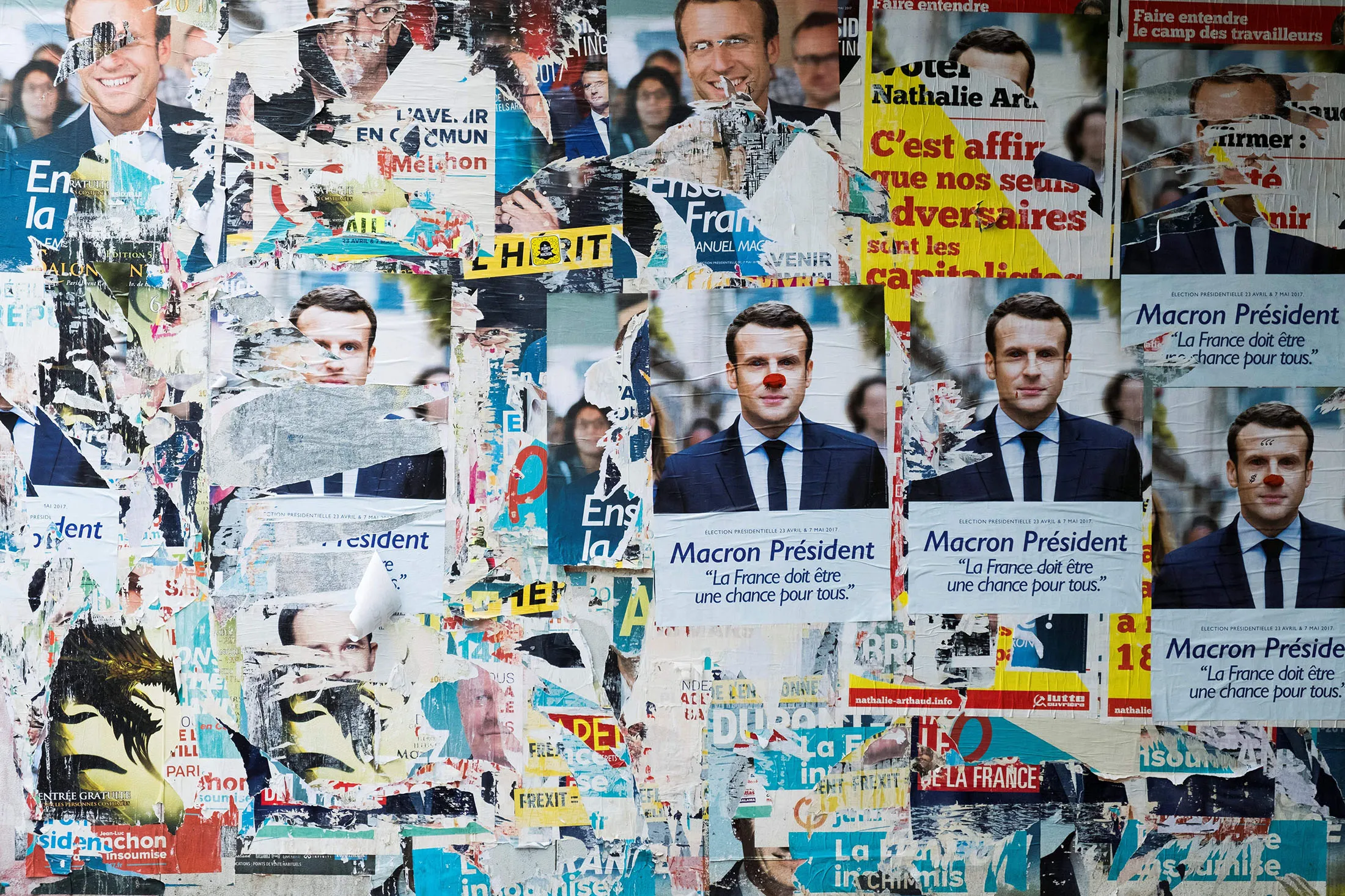 A picture taken in Paris, on May 5, 2017, shows vandalised campaign posters of French presidential election candidate for the En Marche ! movement, Emmanuel Macron. / AFP PHOTO / JOEL SAGET (Photo credit should read JOEL SAGET/AFP/Getty Images)
