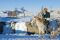 Mongolia, Ovorkhangai, Orkkhon Valley. A man sits on horseback by a frozen waterfall on the Orkhon River.
