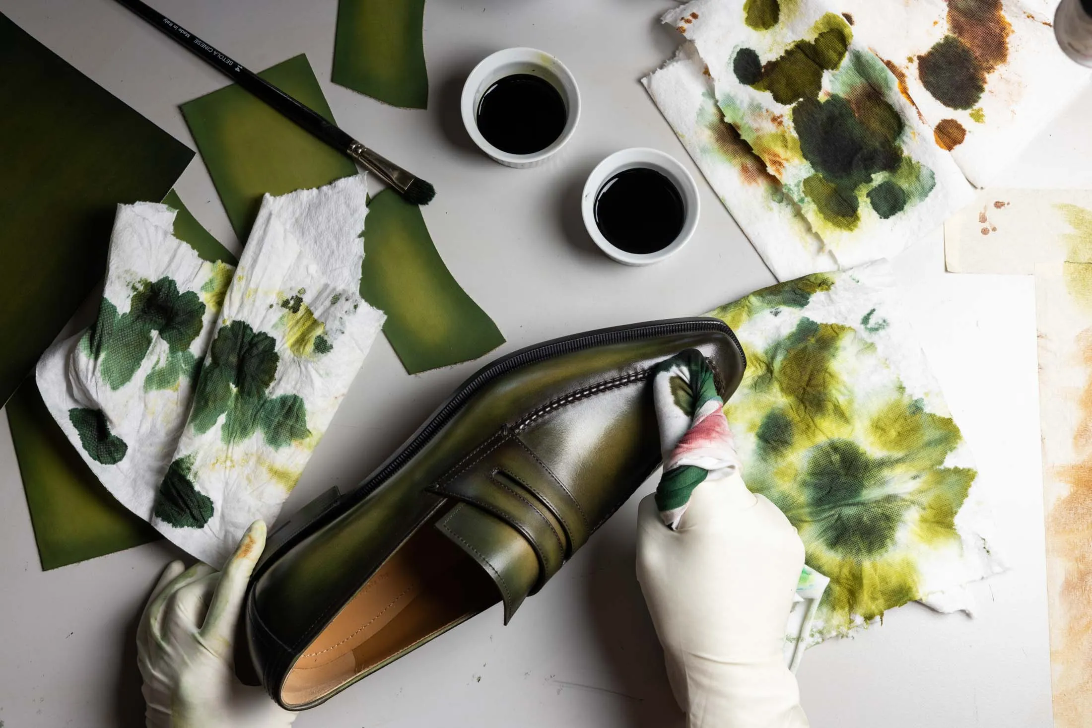 An artisan applies Berluti’s famous “patina” to a pair of leather loafers.