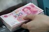 An employee places genuine Chinese one-hundred yuan banknotes into a counting machine at the Counterfeit Notes Response Center of KEB Hana Bank in Seoul, South Korea, on Friday, July 13, 2017. Yuan is set to slide for fifth week, longest losing streak since July 2016, as escalating U.S.-China trade tensions weigh on sentiment.