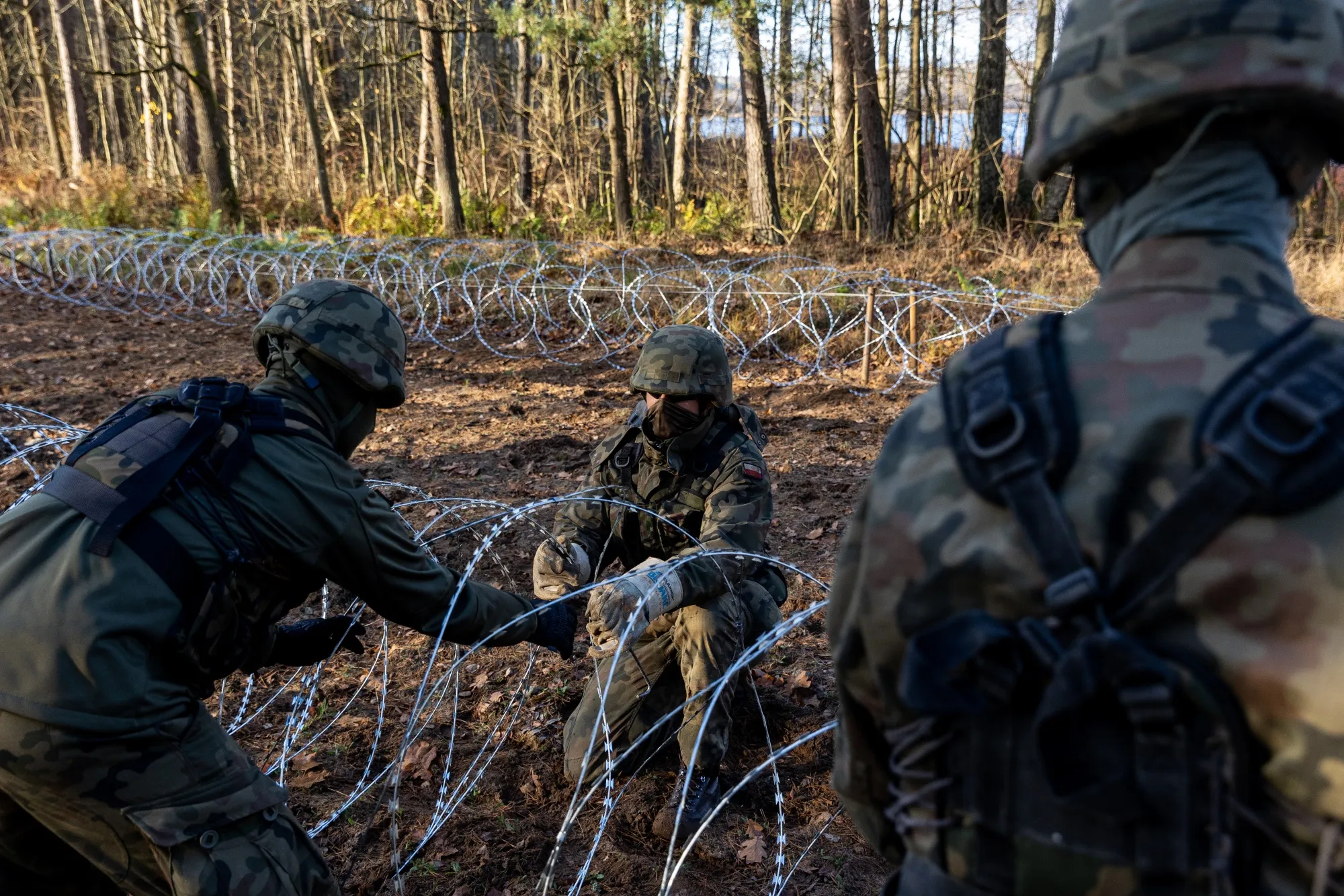 Polish soldiers install razor wire along a stretch of border with Kaliningrad.