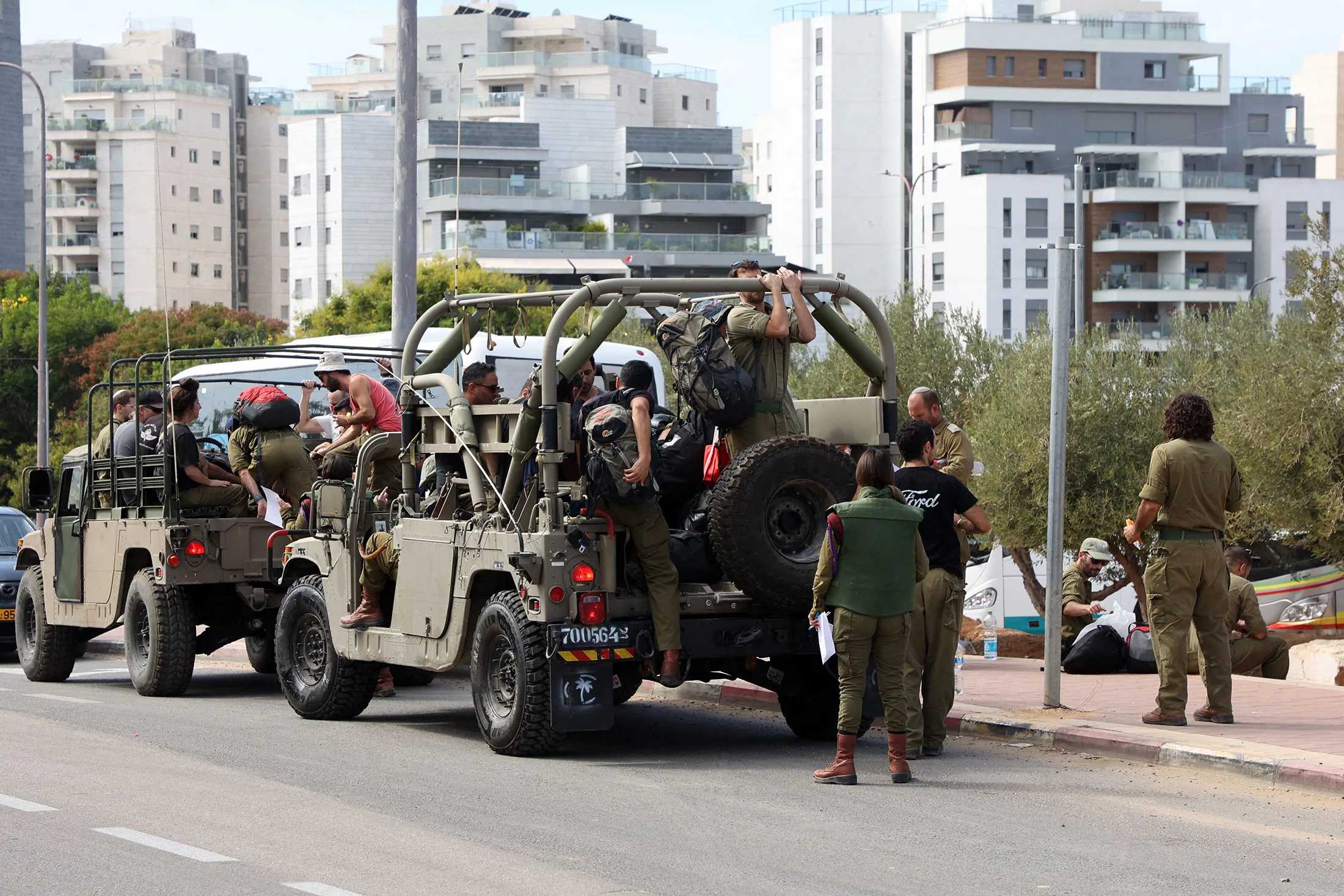 Israeli army reservists are transported in military vehicles to join army bases, south of Tel Aviv on Oct.&nbsp;7.