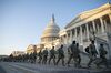 Members of the National Guard walk outside of the U.S. Capitol building in Washington on Jan. 13, 2021.