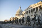 Members of the National Guard walk outside of the U.S. Capitol building in Washington on Jan. 13, 2021.&nbsp;