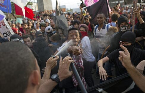 Police pepper spray protesters on the torch route, in Niteroi, on Aug. 2.