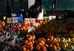 A stall holder serves a customer with fresh fruit and vegetables at a market stall in Croydon, Greater London on&nbsp;Jan. 17.