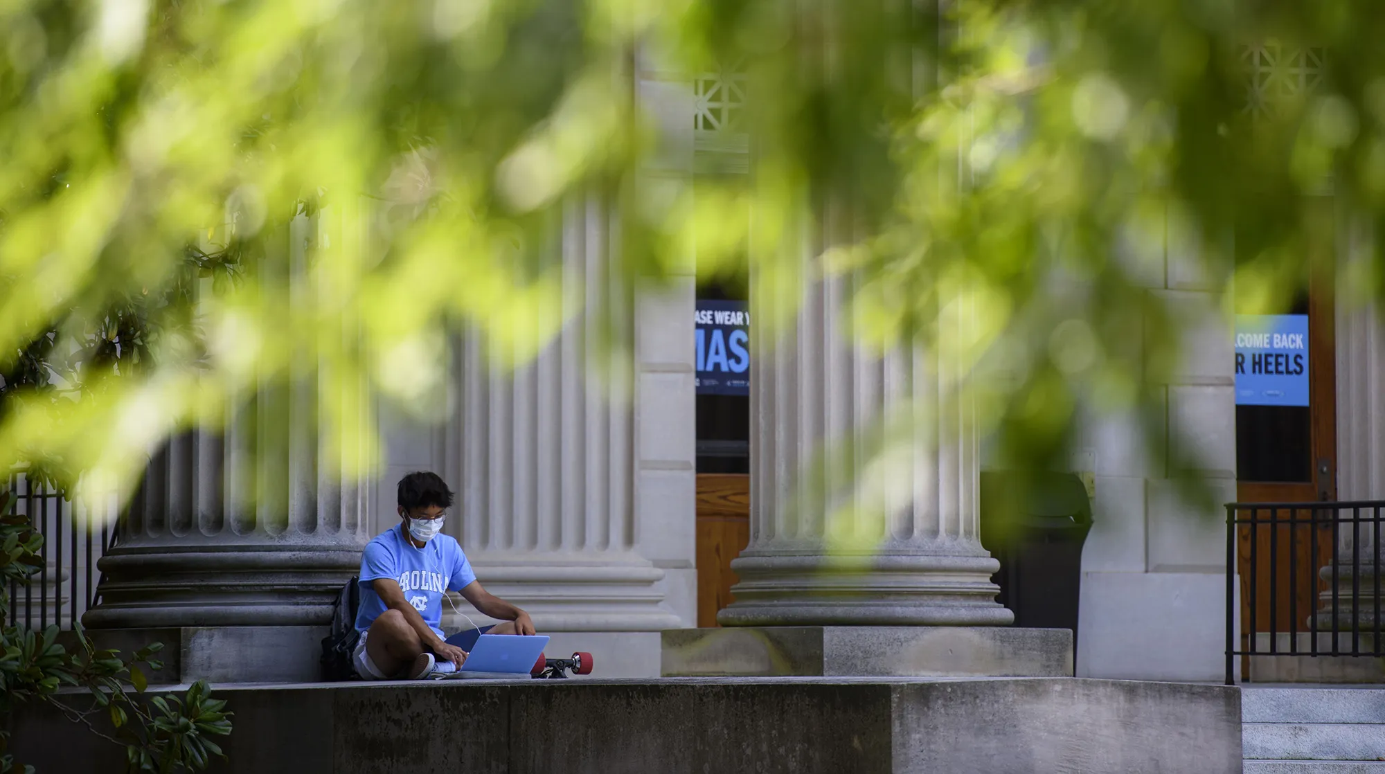 A student studies outside the closed Wilson Library on the campus of the University of North Carolina at Chapel Hill&nbsp;on Aug. 18.&nbsp;&nbsp;
