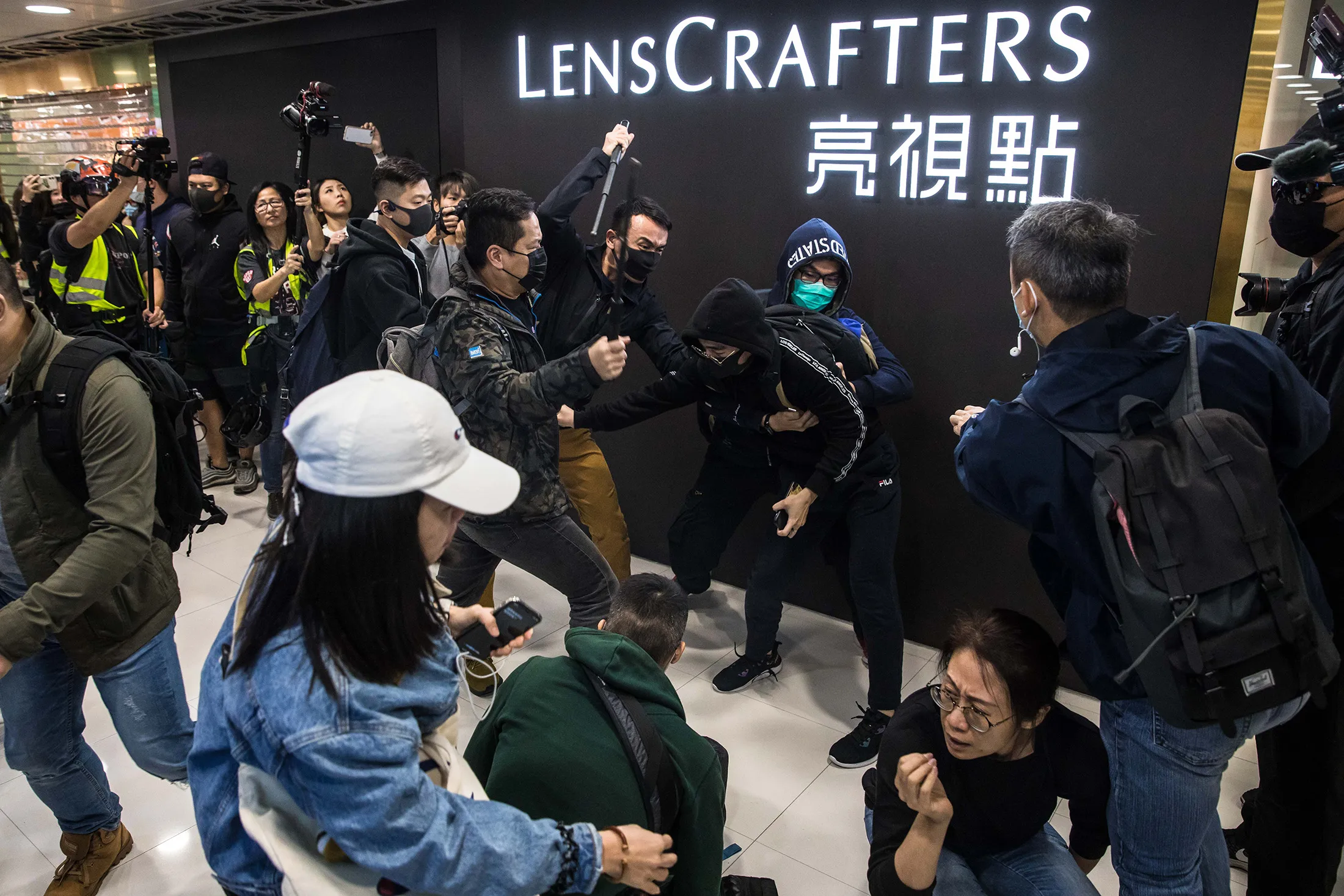 Plainclothes police officers&nbsp;clash with a pro-democracy protester during a rally inside a shopping mall in Sheung Shui in Hong Kong on Dec. 28.