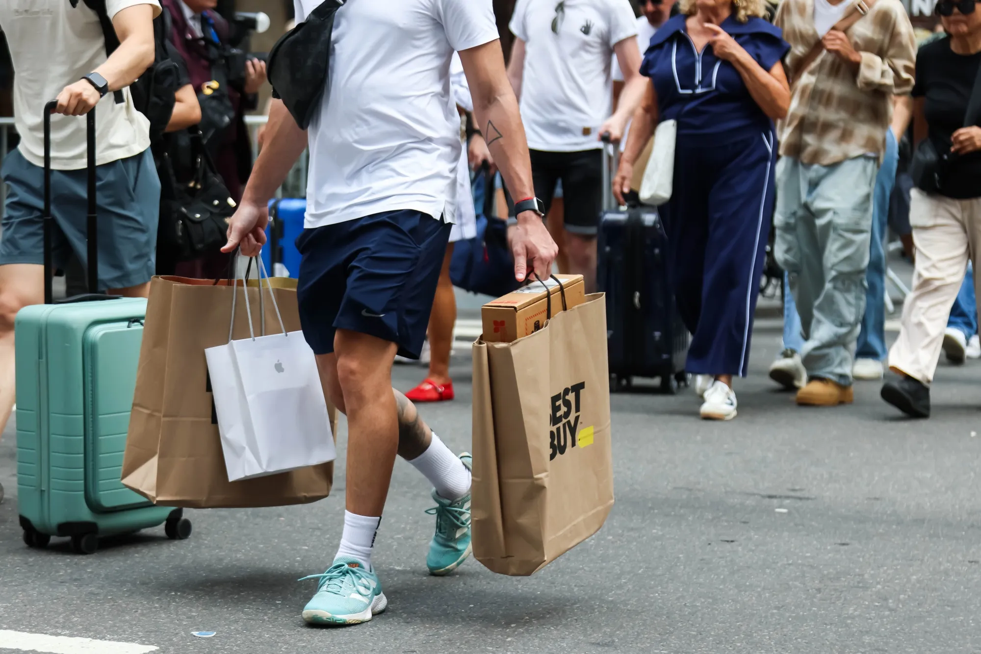 A shopper carries Best Buy store bags in New York.