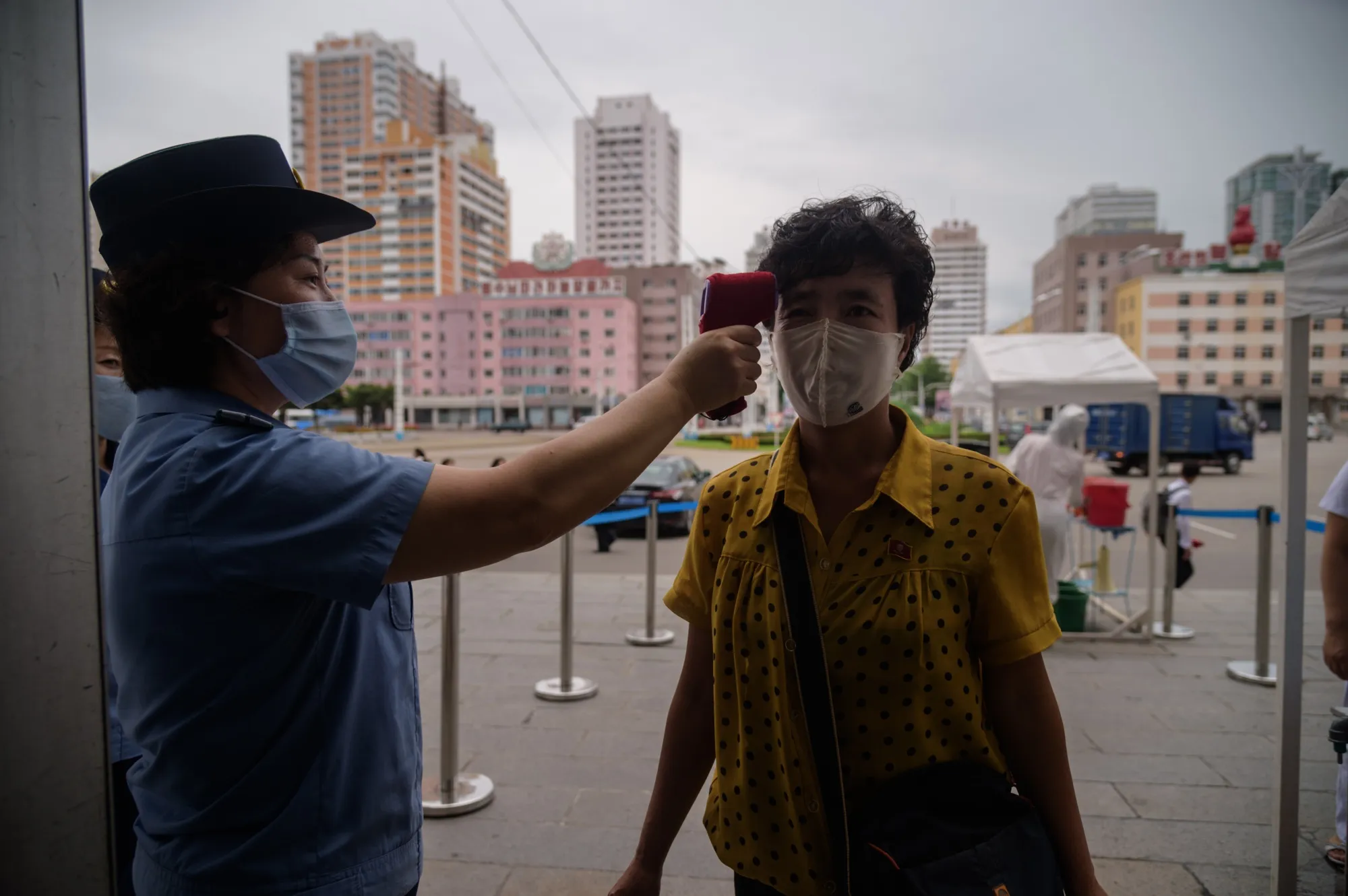 Passengers undergo temperature checks before entering Pyongyang Railway Station.