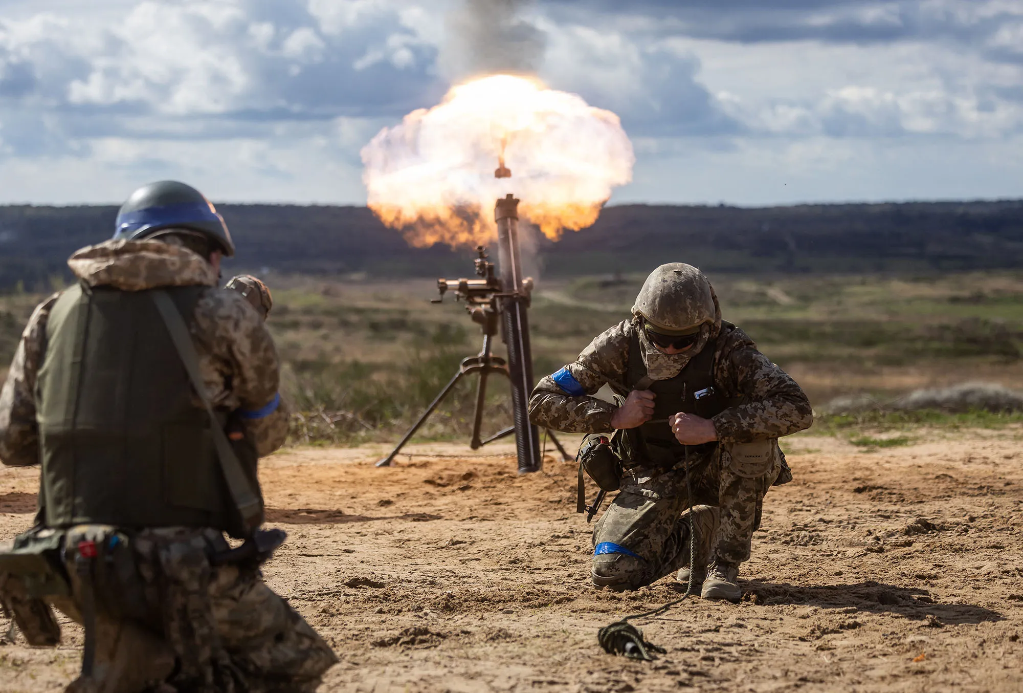 Ukrainian soldiers fire a mortar during a military training exercise.