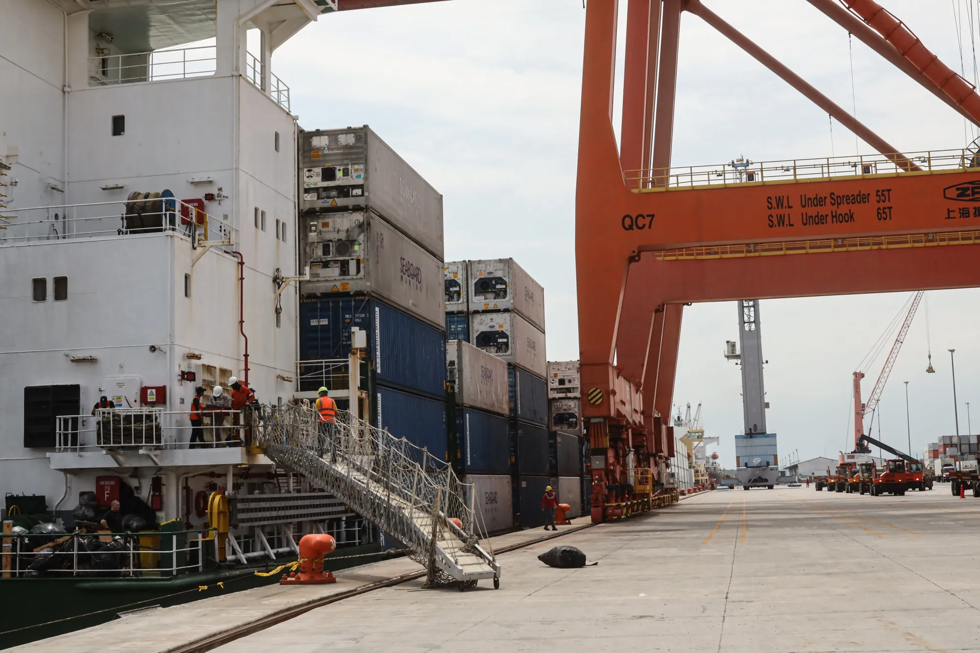 Containers are loaded onto a ship at the Port of Guayaquil in Guayaquil, Ecuador.