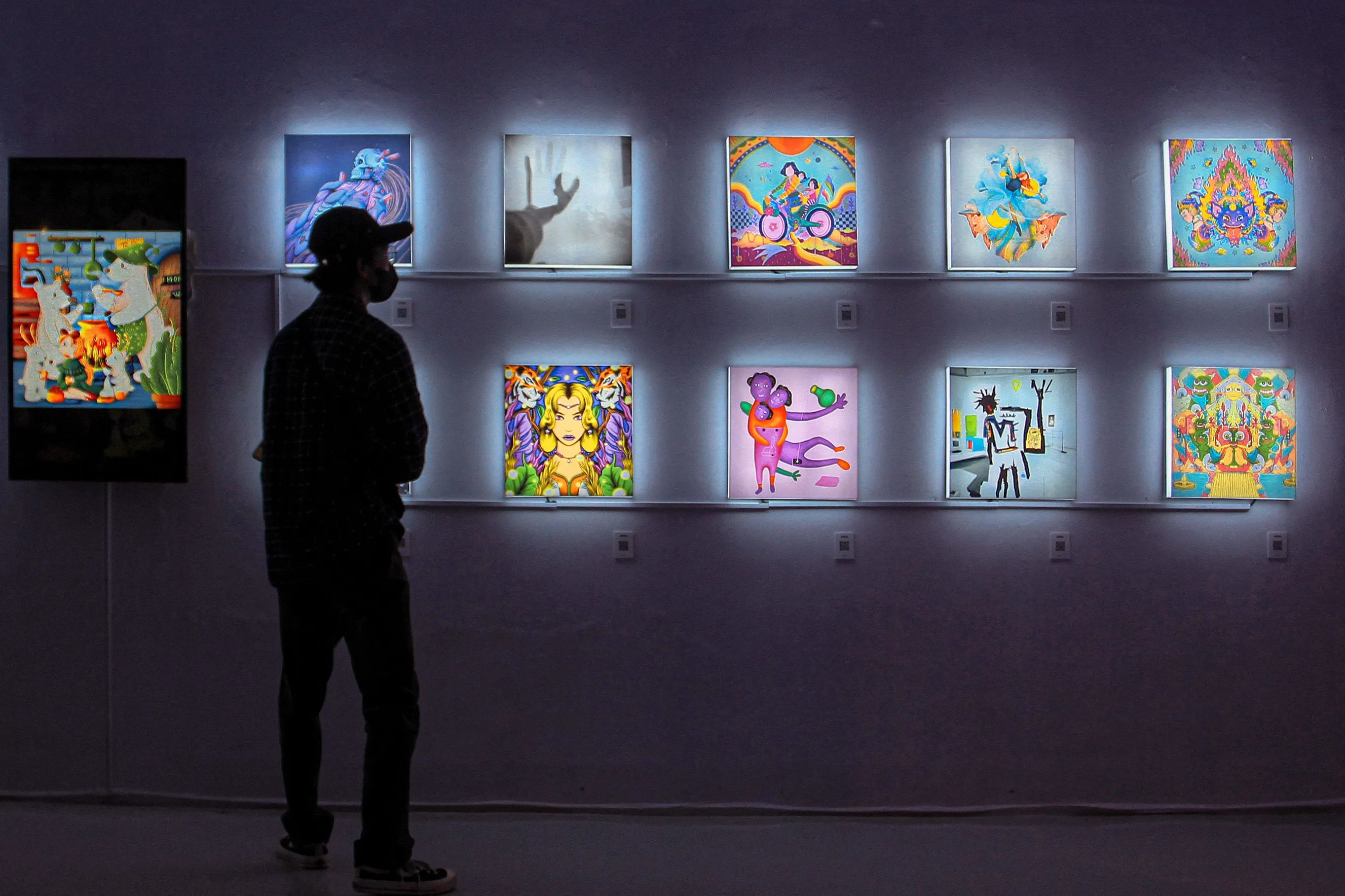 A visitor observes Non-Fungible Token works at an exhibition entitled Indo NFT Festiverse at the RJ Katamsi Gallery, Indonesian Art University in Yogyakarta.