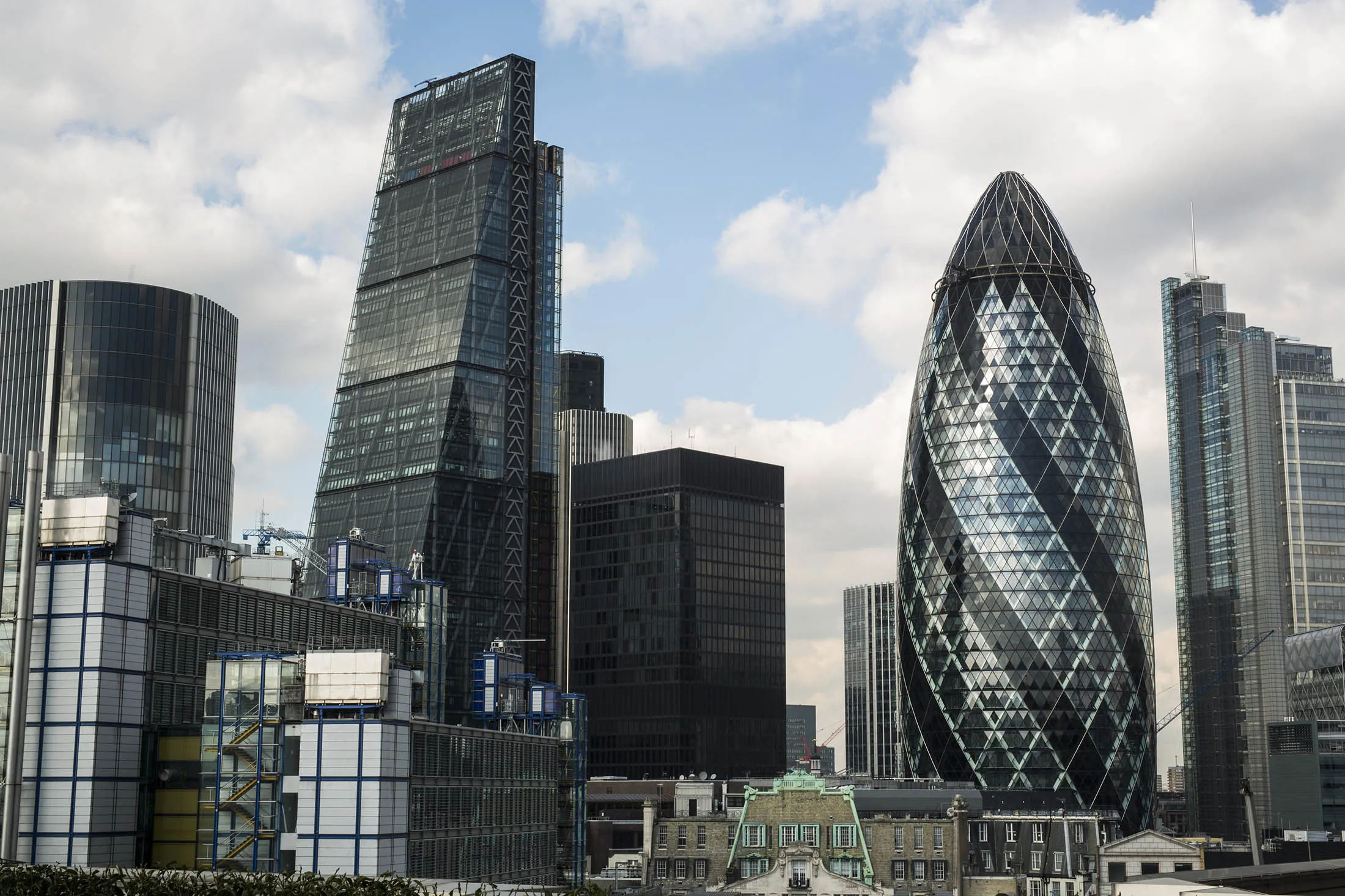 Skyscrapers including the Leadenhall building, also known as the Cheesegrater, second left, 30 St Mary Axe, also known as the Gherkin, second right, and the Heron Tower, right, stand surrounded by commercial office buildings in the City of London, U.K., on Wednesday, Feb. 24, 2016. The U.K. currency has tumbled this year amid concern that Britain will vote to leave the European Union, hampering trading and discouraging foreign investment.
