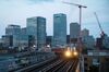 A Docklands Light Railway (DLR) passes the offices of Barclays Plc, and HSBC Holdings Plc in the Canary Wharf financial, business and shopping district as it approaches East India station in London, U.K., on Monday, Aug. 14, 2017. The Docklands Light Railway, a low-capacity rail system connecting the City of London to the Docklands area that carries 122 million passengers a year, began operating on Aug. 31, 1987.