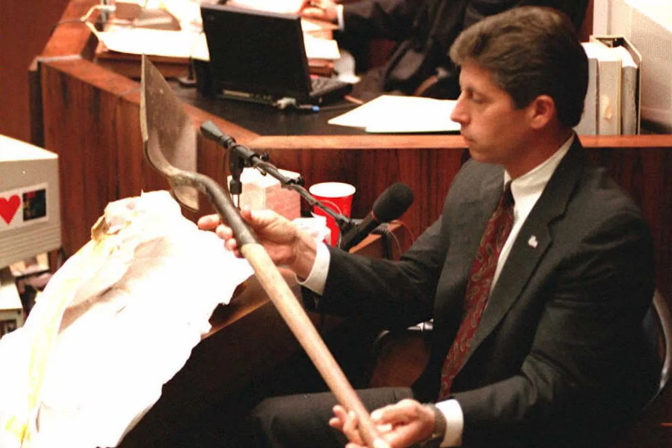 Mark Fuhrman holds up the shovel found in O.J. Simpson's Ford Bronco in 1995.&nbsp;