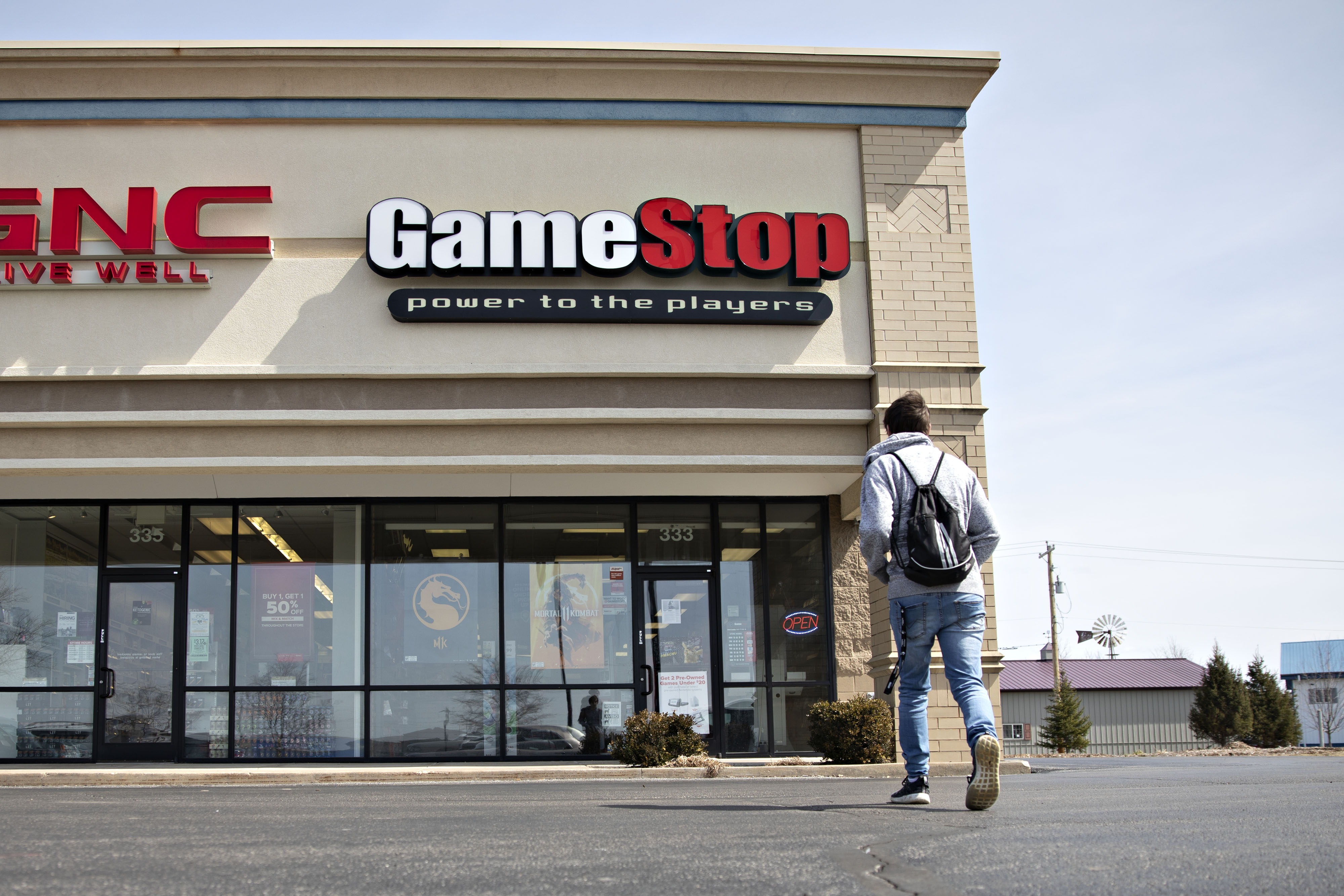 A shopper walks toward a GameStop Corp. store in Ottawa, Illinois.