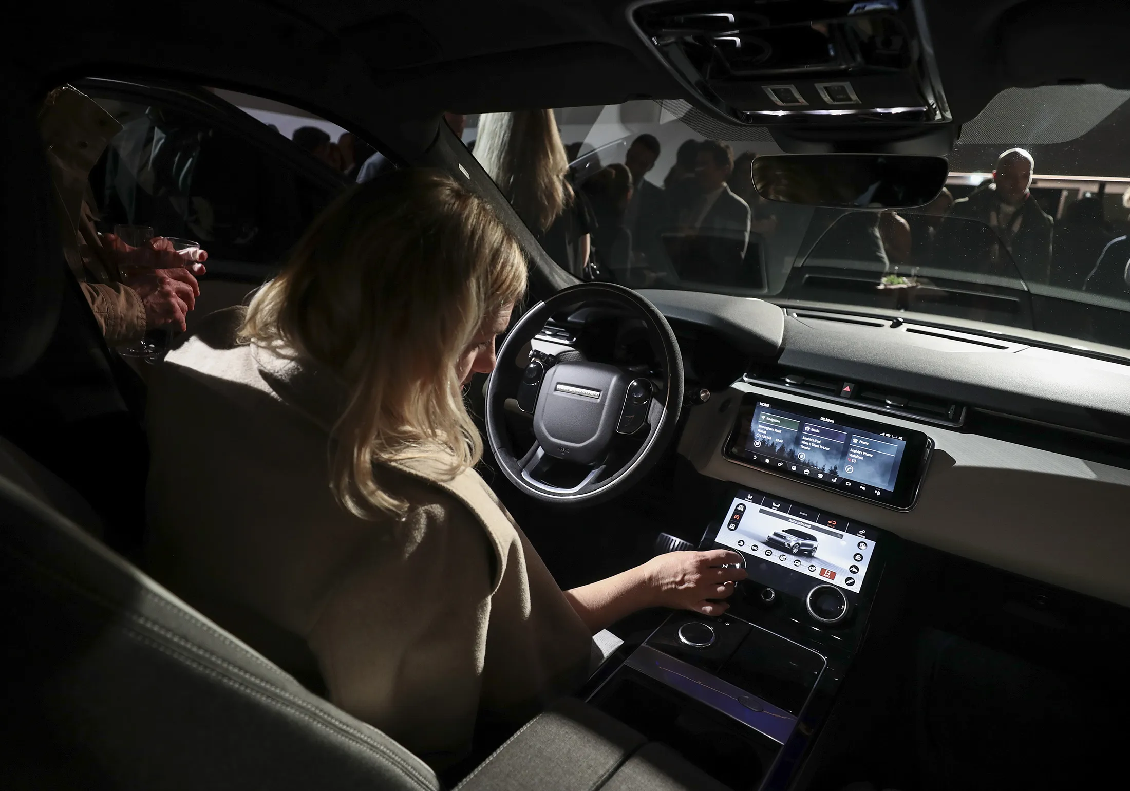 An attendee interacts with the onboard computer for the Range Rover Velar.
