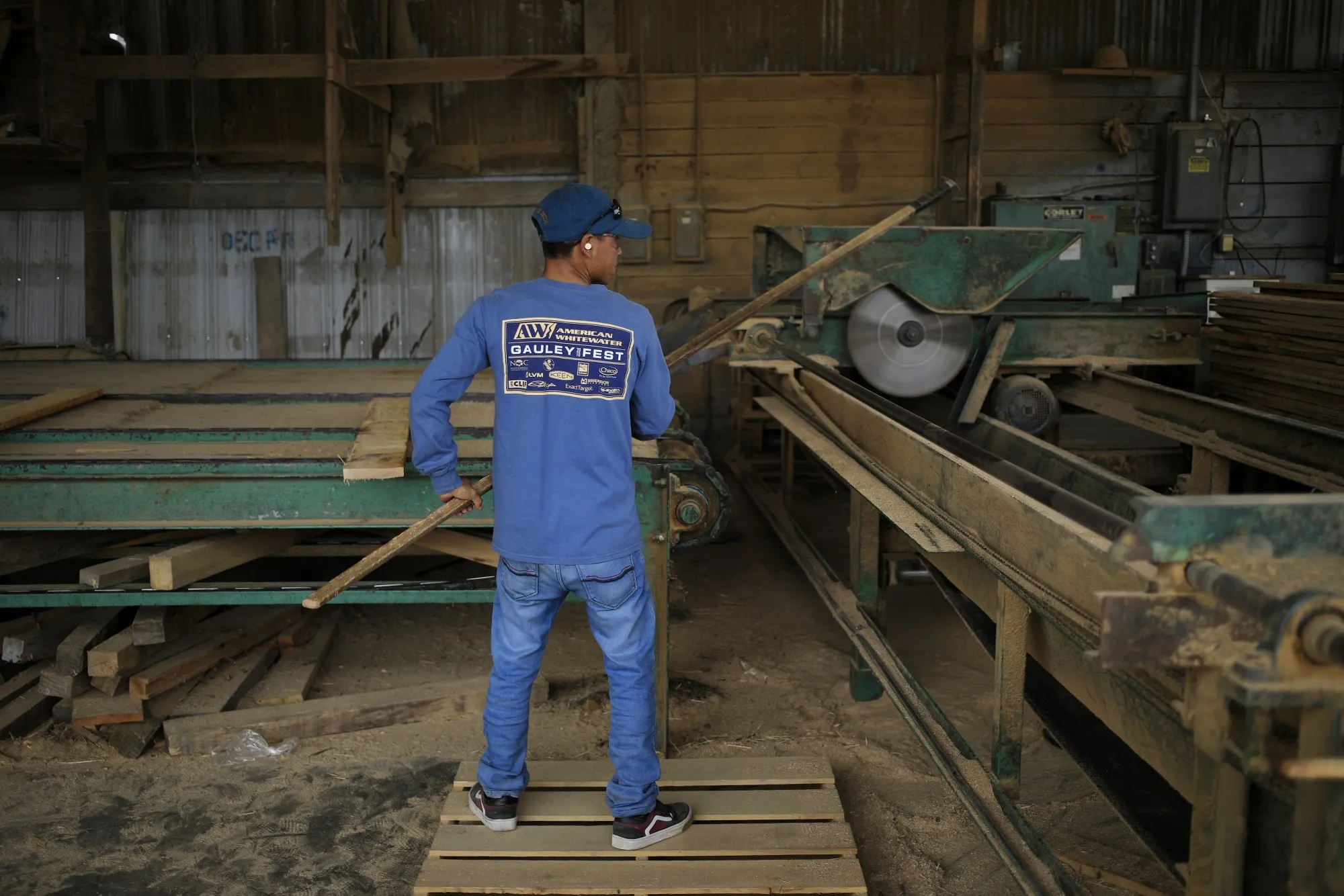A worker mills wooden boards at Harold White Lumber in Morehead, Kentucky.