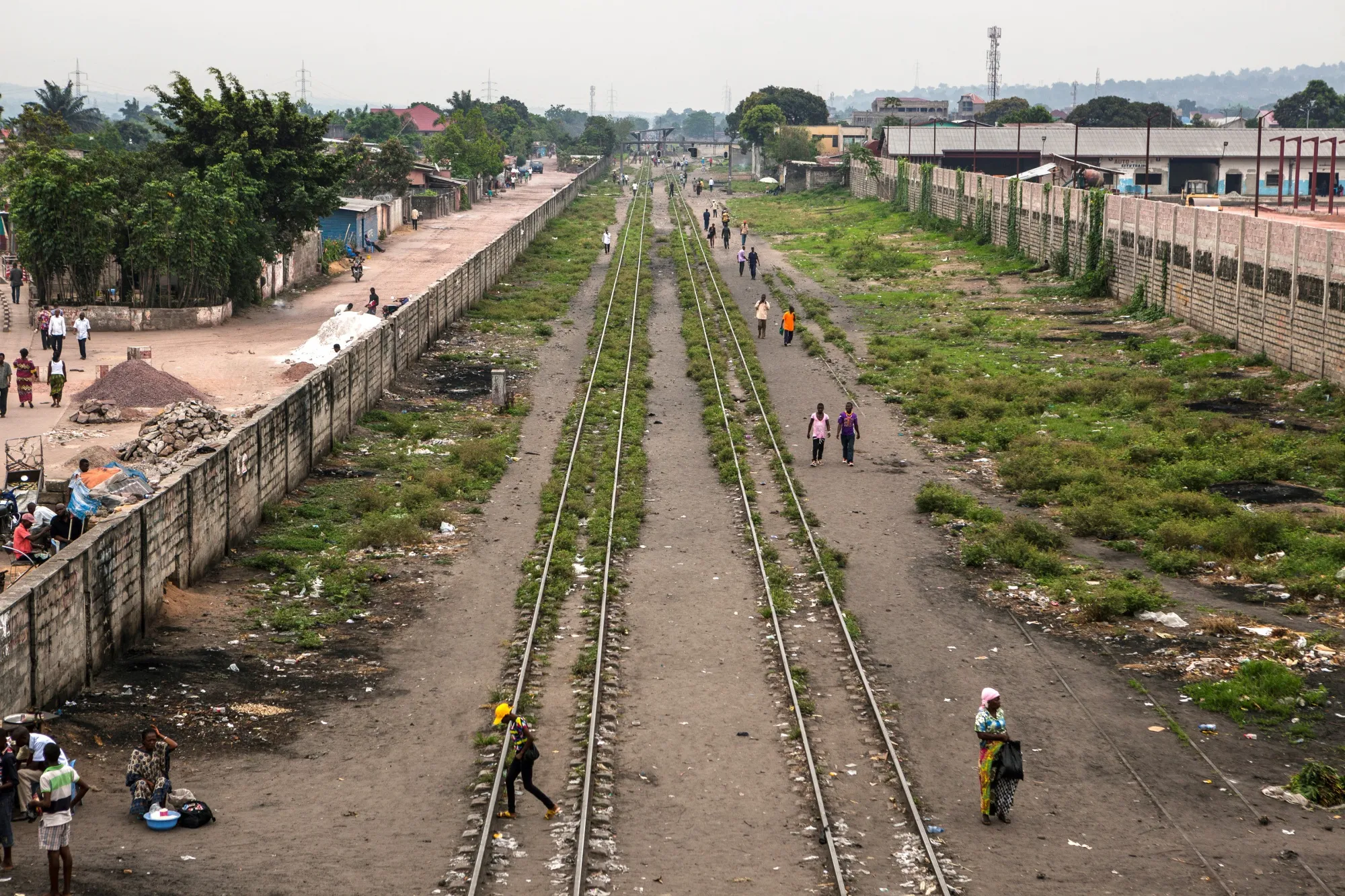 People walk along the railroads near&nbsp;Kinshasa