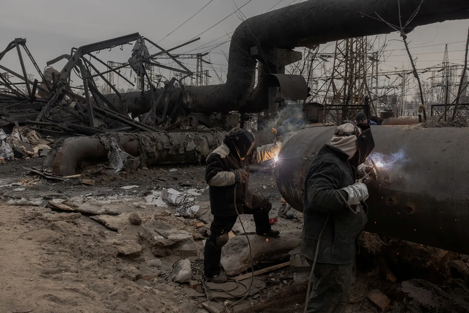 Employees repair sections of the Darnytska combined heat and power plant damaged by Russian air strikes in Kyiv, on Feb. 4.&nbsp;