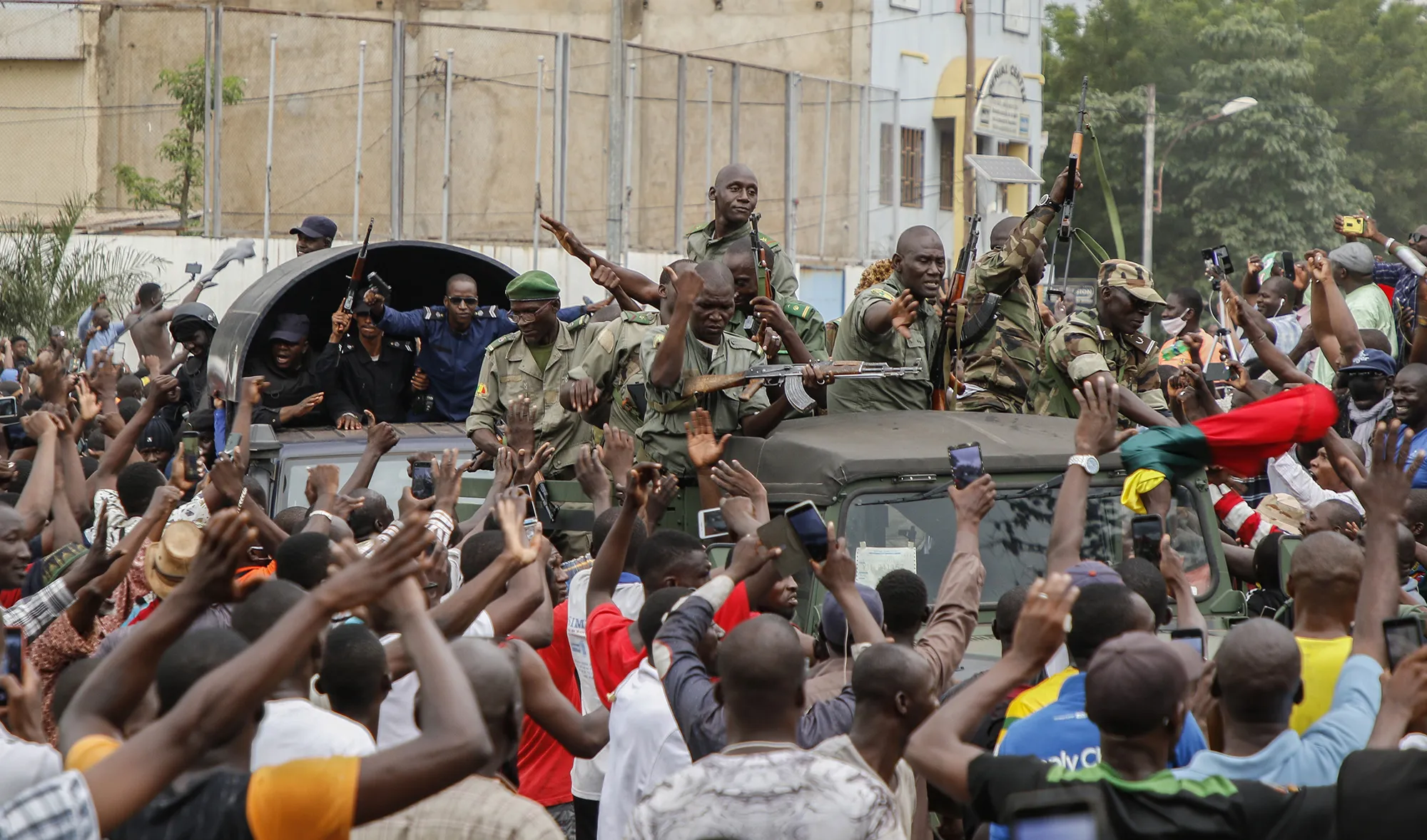 Crowds cheer as soldiers parade in vehicles along the Boulevard de l'Independance&nbsp;in Bamako on Aug. 18.&nbsp;