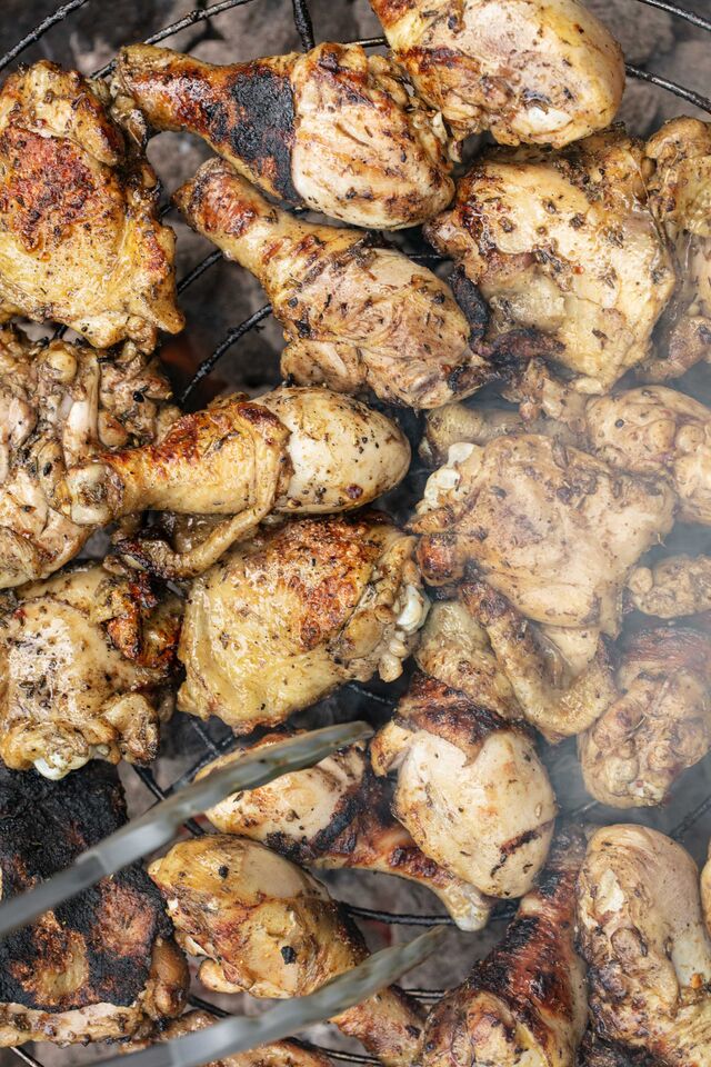 Chicken being roasted on a grill.