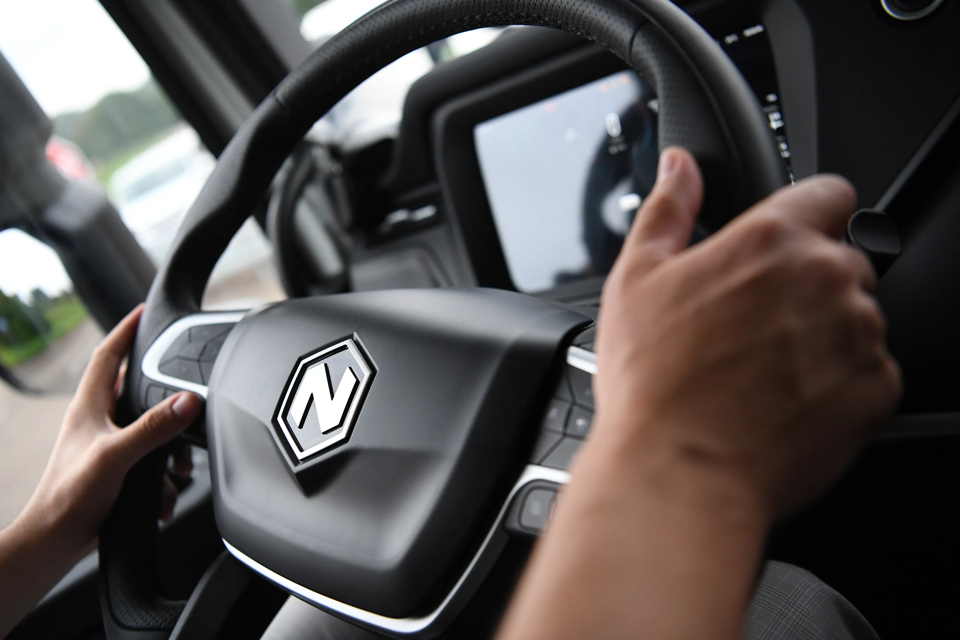 A test driver at the steering wheel of a Nikola Tre&nbsp;truck in Ulm, Germany.