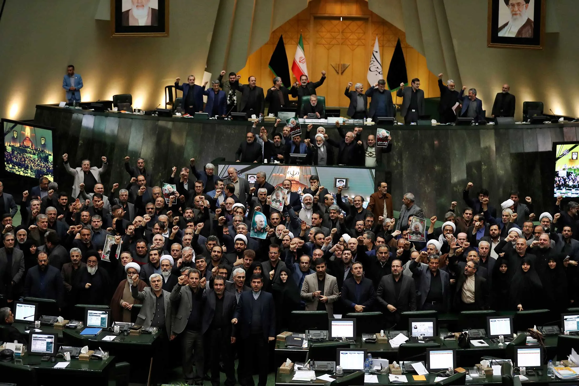 In an open session of parliament on Jan. 7, Iranian lawmakers&nbsp;chant slogans while some hold posters of General Qassem Soleimani, who was killed days earlier&nbsp;in a U.S. drone attack in Iraq.