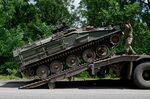 Ukrainian soldiers unload an armored&nbsp;personnel carrier in eastern Ukraine.
