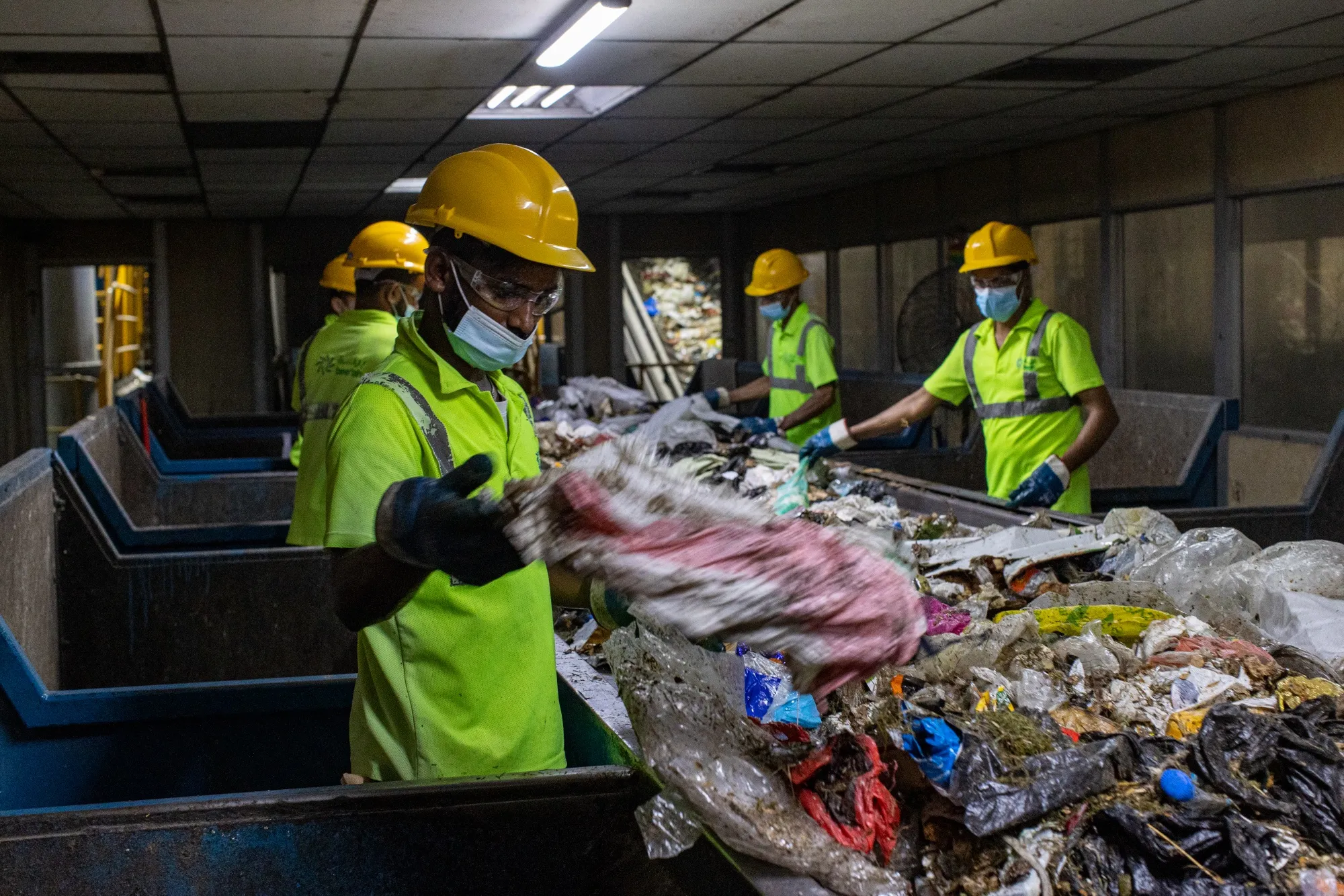 Workers sort waste at the Bee'ah waste management complex in Sharjah, United Arab Emirates.