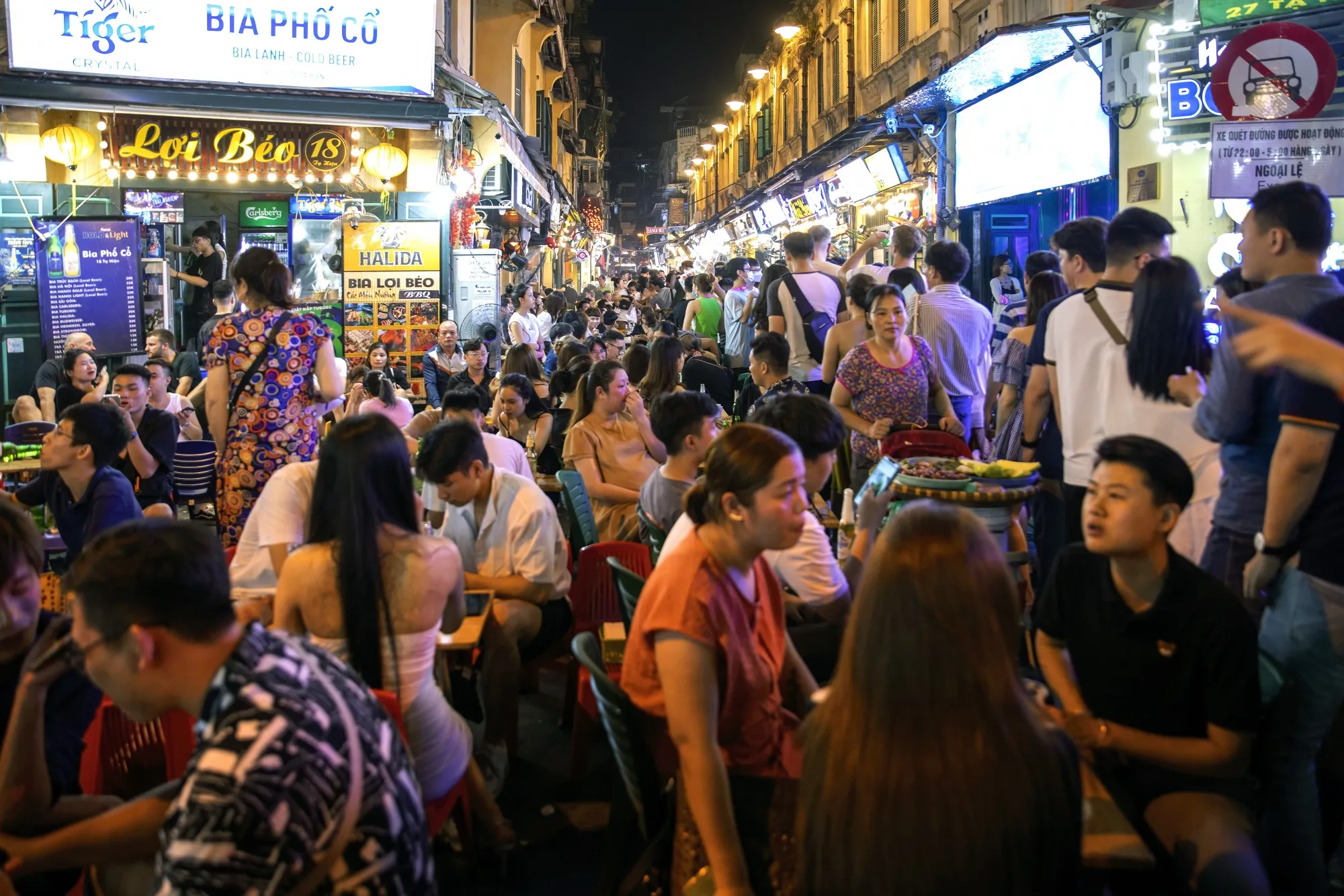 People dine on Ta Hien Street in Hanoi, Vietnam.