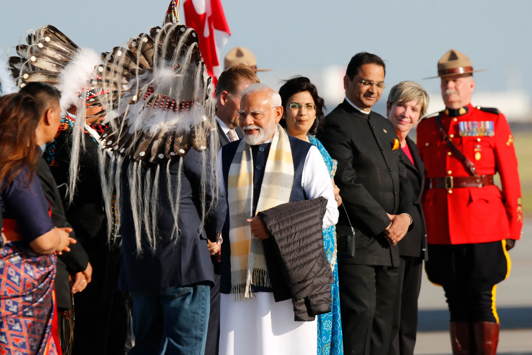 Indian Prime Minister Narendra Modi, center, arrives at Calgary Airport on June 16.