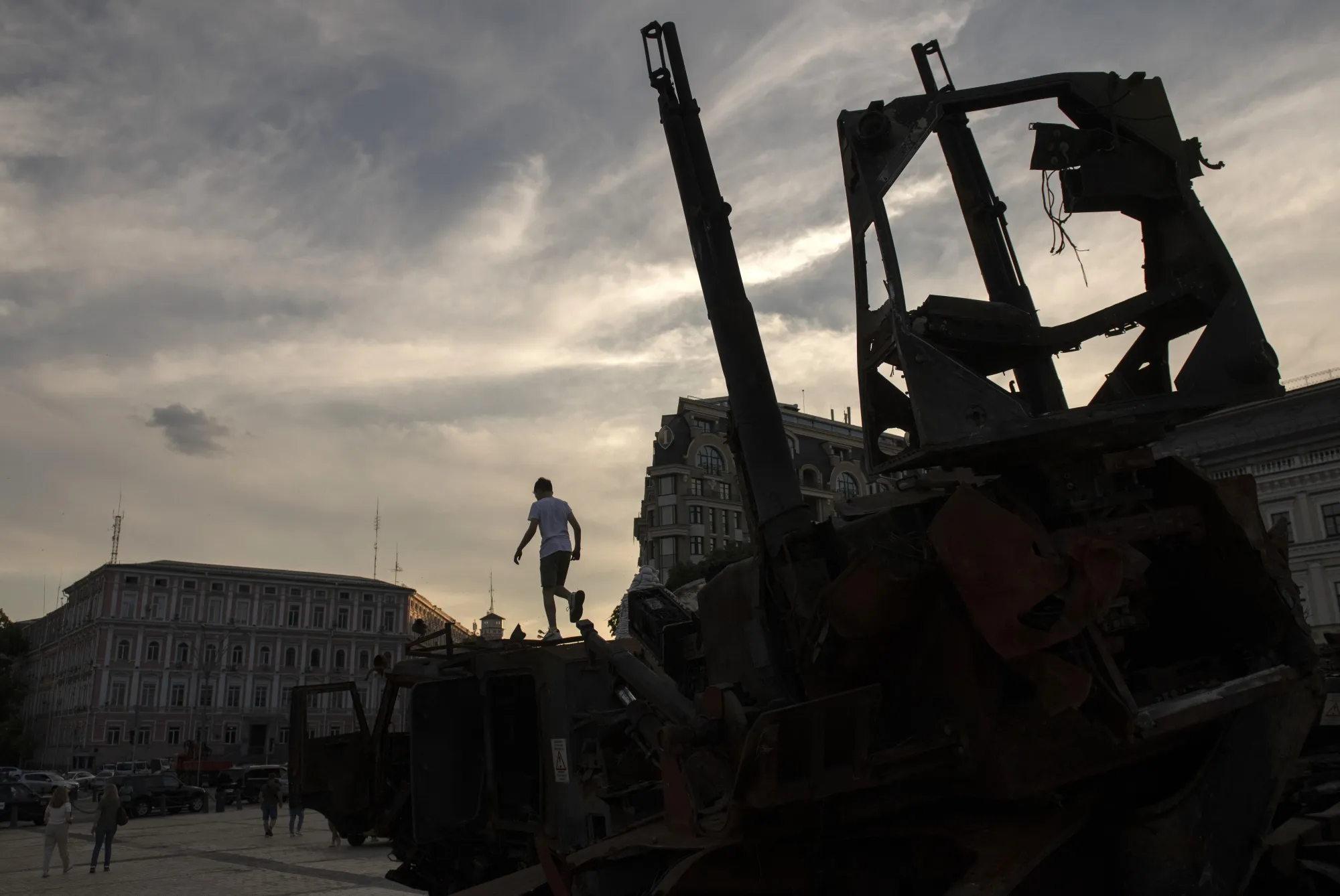 A child climbs on top of a piece of destroyed Russian military equipment displayed at St. Michael's Square in Kyiv in June.