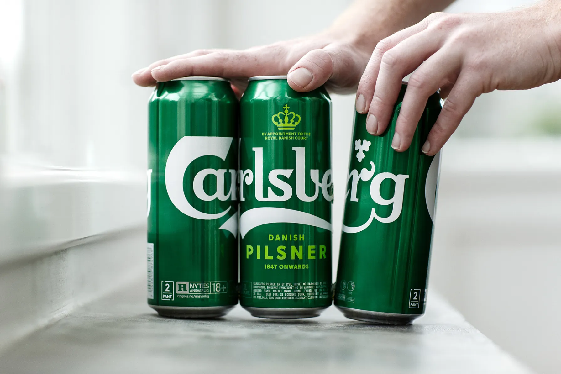 A beer can is separated from its pack.