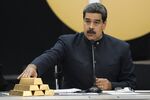 Maduro speaks as he touches a stack of 12 Kilogram gold ingots in Caracas.