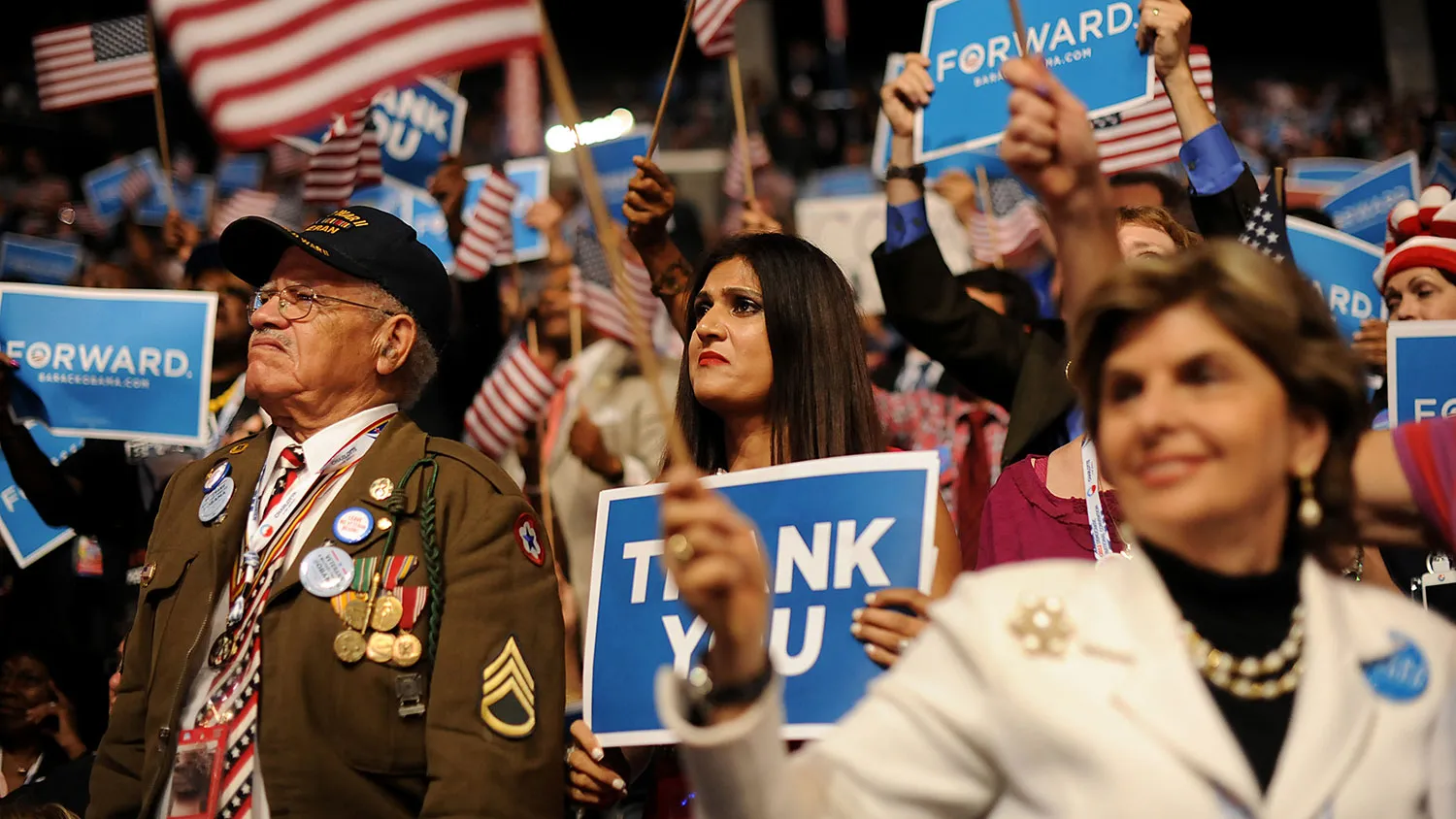 Delegates hold signs and U.S. flags while listening to President Barack Obama speak during the Democratic National Convention in Charlotte, North Carolina, on Sept. 6, 2012.
